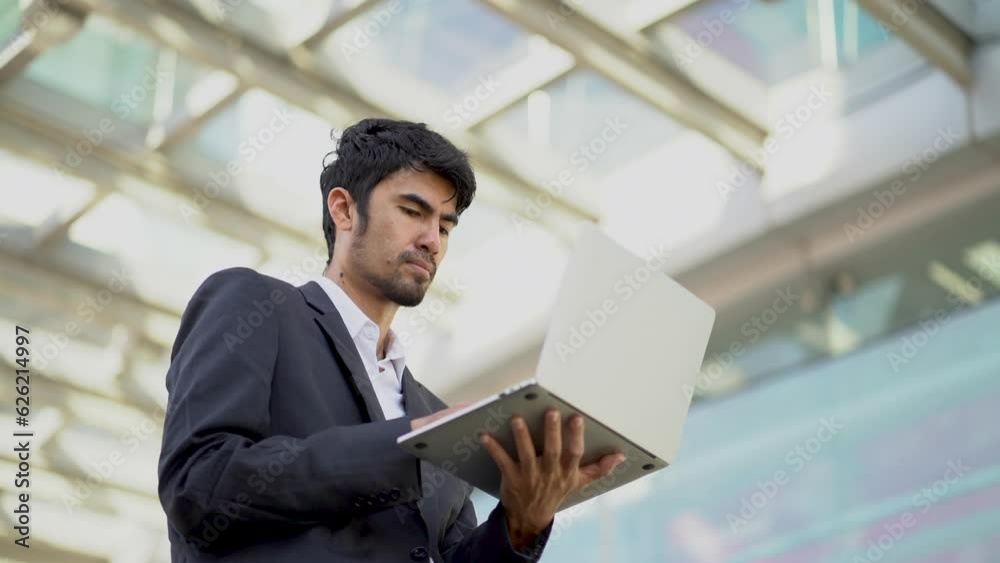 Portrait of Asian businessman holding laptop.Office worker at business center. Portrait of Asian businessman holding laptop.Office worker at business center.