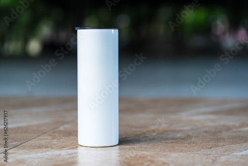 An expertly crafted mockup exhibits a white tumbler arranged with a simple style, ready to elevate your designs