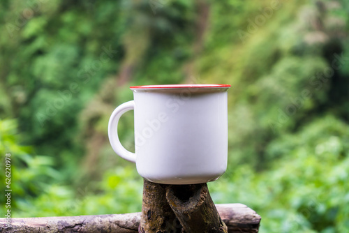 Professionally staged, the mockup features a white blank mug in the tranquility of nature, elegantly arranged with simple style