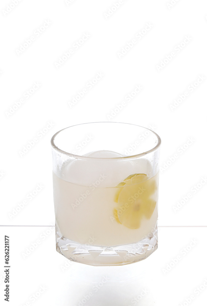 Cocktails and ice spheres (round shape) in glasses with sliced lemon isolated on white background. Cocktails and ice spheres (round shape) in glasses with sliced lemon isolated on white background.