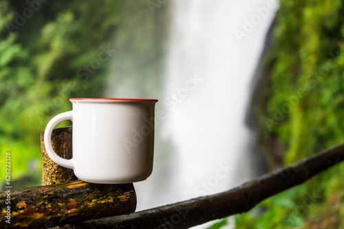 A visually appealing mockup image showcases a white blank mug, elegantly arranged with a simple style in the natural environment