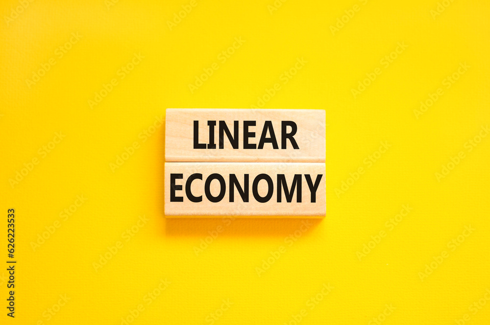 Linear economy symbol. Concept words Linear economy on beautiful wooden block. Beautiful yellow table yellow background. Business linear economy concept. Copy space. Linear economy symbol. Concept words Linear economy on beautiful wooden block. Beautiful yellow table yellow background. Business linear economy concept. Copy space.