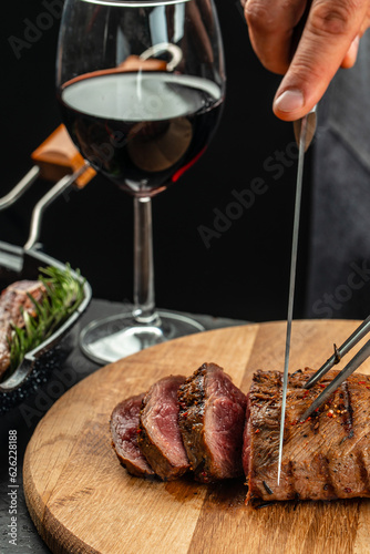sliced beef grill steak with red wine. The concept of cooking meat