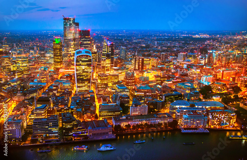 City of London business and banking area at nigh with beautiful lit up skyscrapers and streets. UK