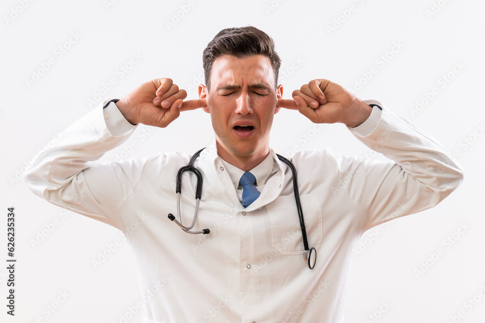 Image of overworked doctor with hands in ears .	