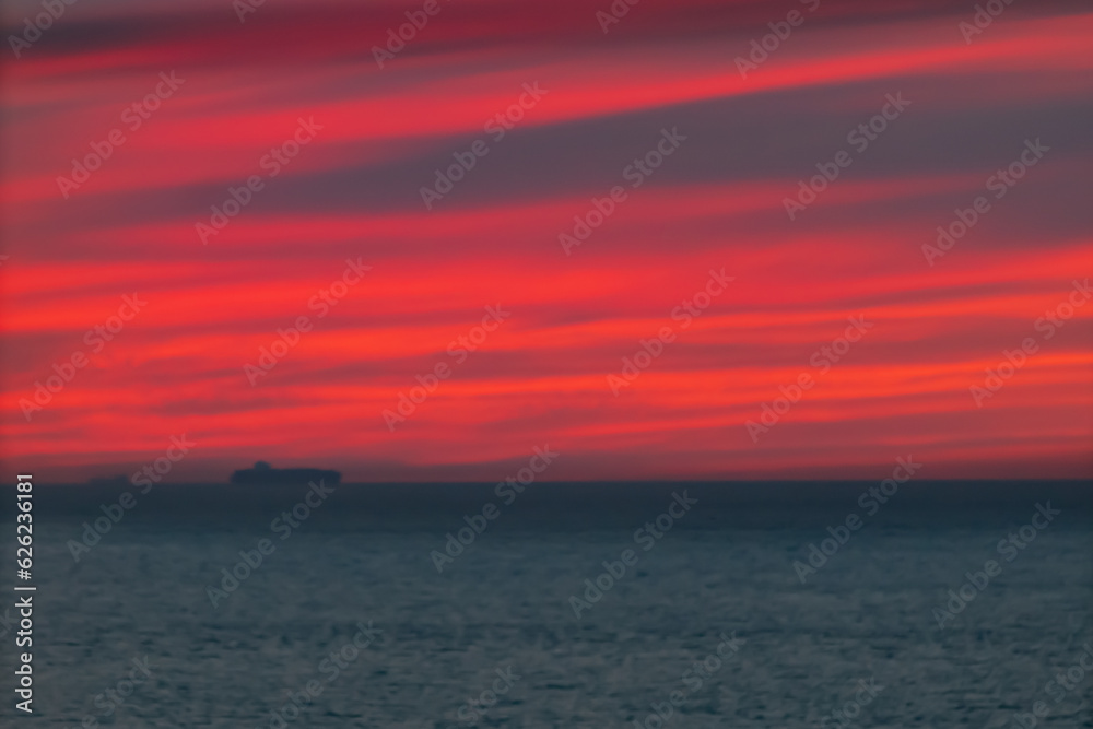 Panoramic view of the ocean sunset against the background of multi-colored stratus clouds. Natural background for abstract reflection, relaxation, blank for designers, visual images, unique moments