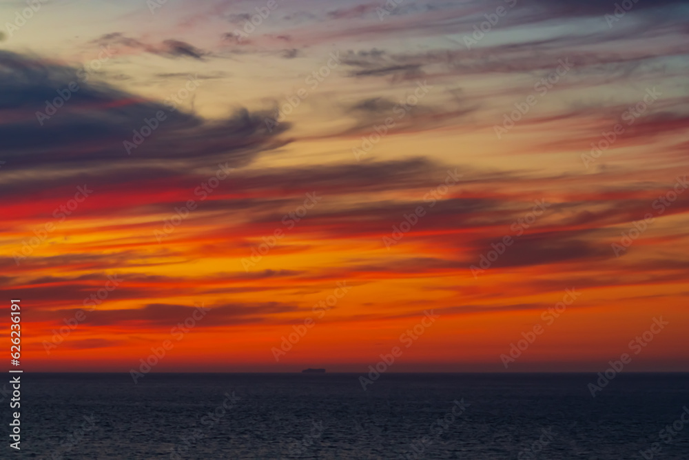 Panoramic view of the ocean sunset against the background of multi-colored stratus clouds. Natural background for abstract reflection, relaxation, blank for designers, visual images, unique moments