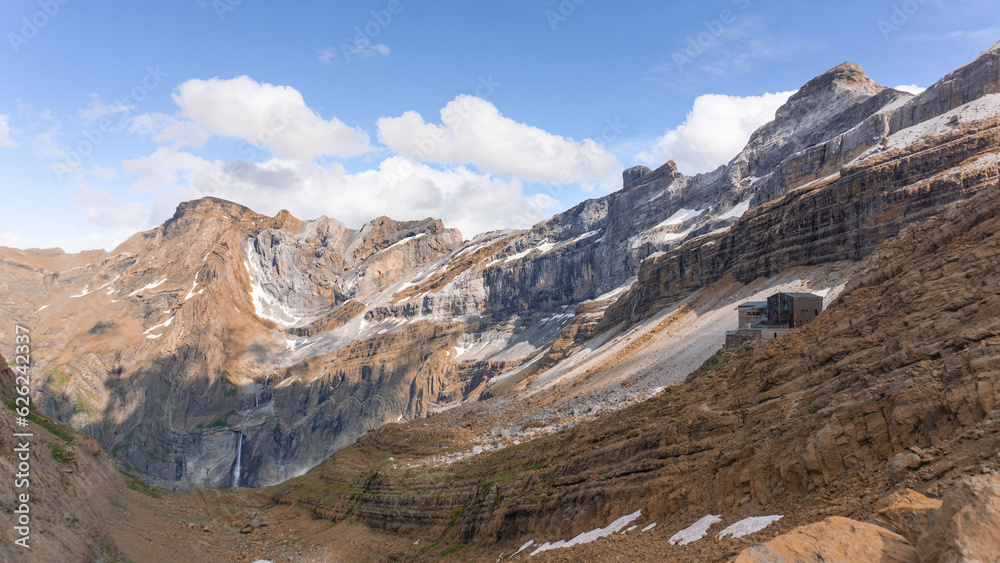 Spectacular view of the Refuge des Serradets with Cirque du Gavarnie at the background and with snow covering the hills