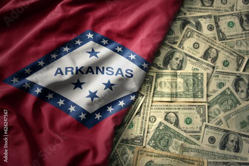 colorful waving national flag of arkansas state on a american dollar money background. finance concept
