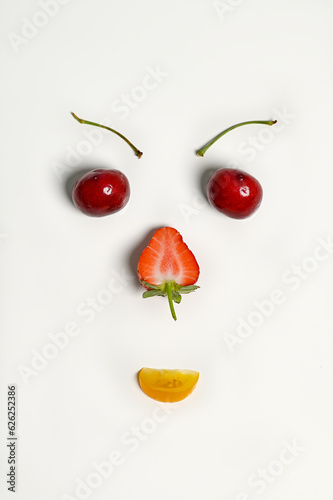 A face look alike setup made with summer fruits isolated on white background 
