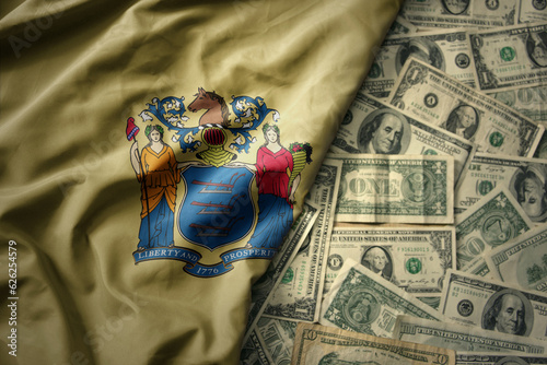 colorful waving national flag of new jersey state on a american dollar money background. finance concept