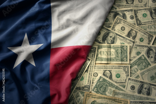 colorful waving national flag of texas state on a american dollar money background. finance concept
