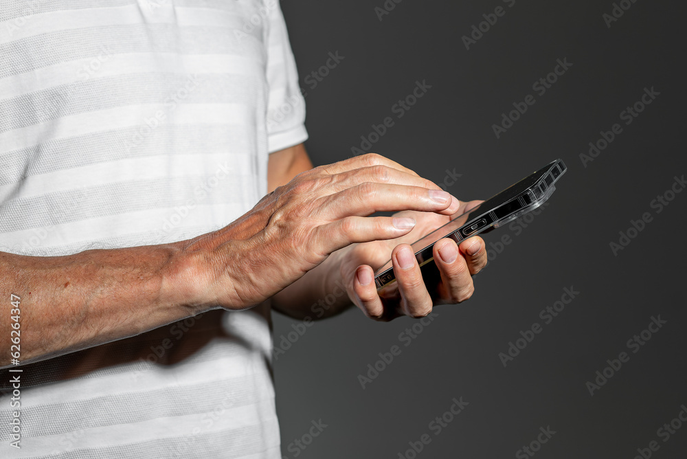 Hand holding mobile phone, scrolling, browsing online