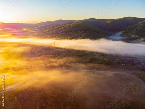 Photos of the hills and the village were taken from a drone in the early morning. Kuldur is an urban—type settlement in the Irradiation district of the Jewish Autonomous Region of Russia. Resort. 
