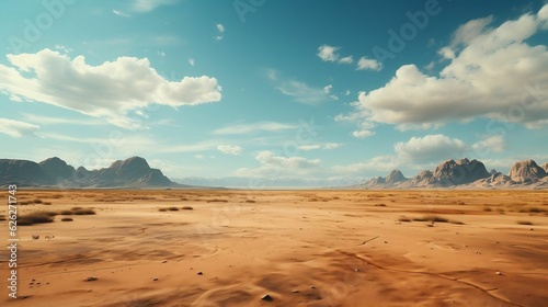 Barren desert landscape with jagged sand, clear sky photo