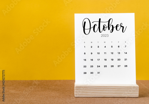 The October 2023 Monthly calendar for 2023 year on yellow table.