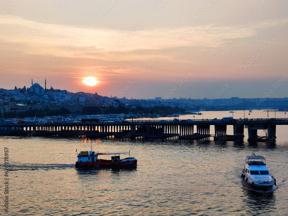 Naklejka premium Ships and bridge across the Bosphorus in Istanbul at sunset
