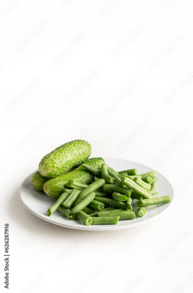 Fresh cucumbers with green beans isolated on white Fresh cucumbers with green beans isolated on white