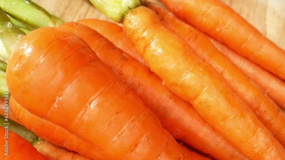 Baby carrots, popular since the 1980s, emerged when farmer Mike Yurosek transformed imperfect carrots into smooth, appealing shapes using a cutter. Macro video. Food and vegetable concept. 4K
Baby carrots, popular since the 1980s, emerged when farmer Mike Yurosek transformed imperfect carrots into smooth, appealing shapes using a cutter. Macro video. Food and vegetable concept. 4K