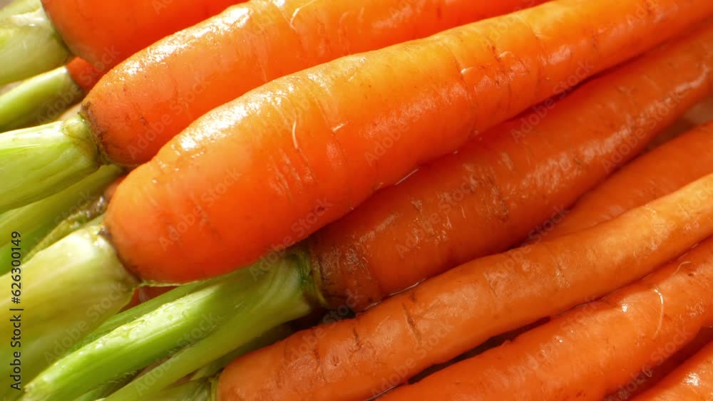 Macro video of baby carrots with probe lens: Witness vibrant orange hues, intricate textures, and fine water droplets on tender carrot skin, revealing nature's miniature wonders. Food concept
Macro video of baby carrots with probe lens: Witness vibrant orange hues, intricate textures, and fine water droplets on tender carrot skin, revealing nature's miniature wonders. Food concept