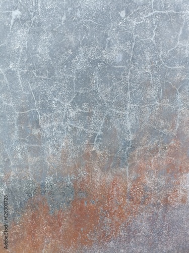 Acid washed concrete floor with random chalky white grid lines and faded red overspray in the lower right corner
