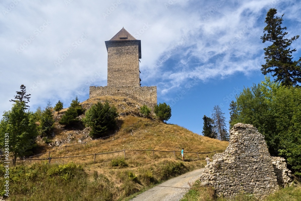 The Gothic castle of Kašperk in the Šumava foothills and the path leading to this protected monument
