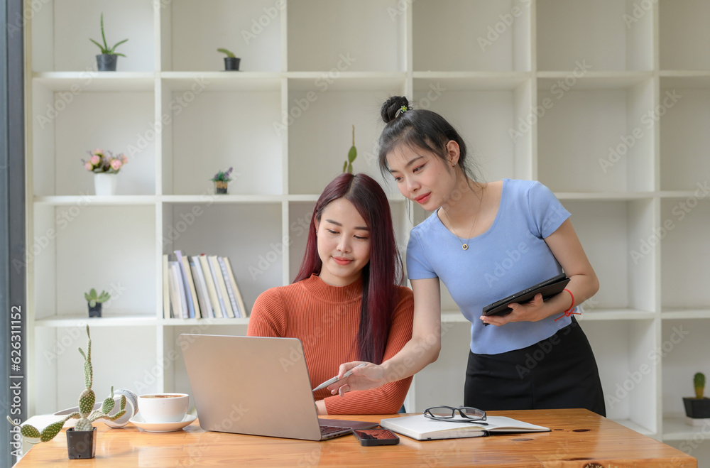Two young freelance businesswoman discuss management planning. new startup project ideas planning and statistics and the investment market at the office Two young freelance businesswoman discuss management planning. new startup project ideas planning and statistics and the investment market at the office