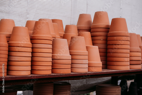 Stacked terracotta flower pots on the shelves at the garden center