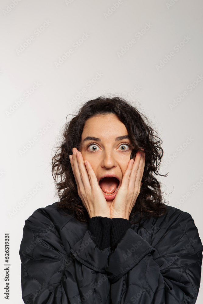 Beautiful girl with curly hair and bright emotions on white background Beautiful girl with curly hair and bright emotions on white background