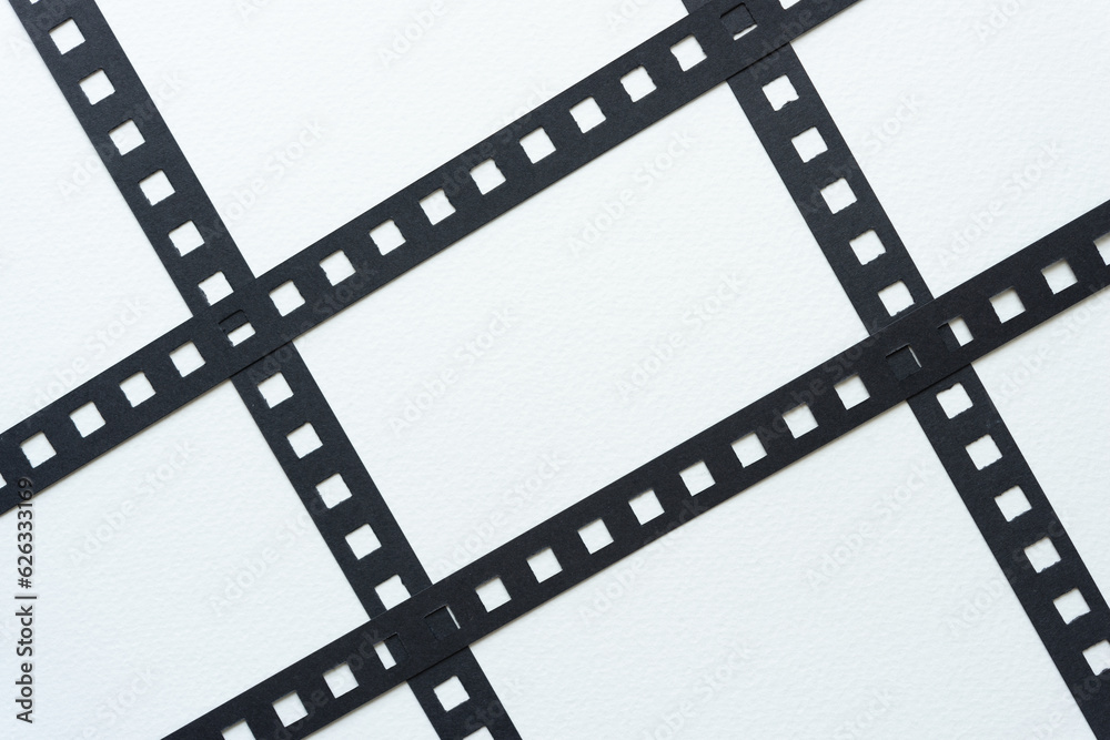 black paper stripes with square holes on white paper black paper stripes with square holes on white paper