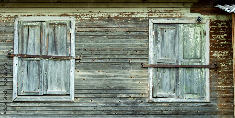 closed wooden windows of an abandoned village store,backgrounds closed wooden windows of an abandoned village store,backgrounds