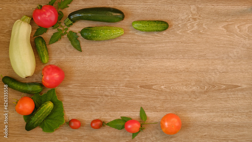 tomatoes, zucchini and cucumbers on an oak background with copy space