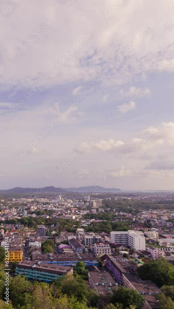 vertical timelapse aerial view of phuket town city skyline with many buildings housing in the central business district with background of bay area and seascape ocean in daytime. vertical timelapse aerial view of phuket town city skyline with many buildings housing in the central business district with background of bay area and seascape ocean in daytime.