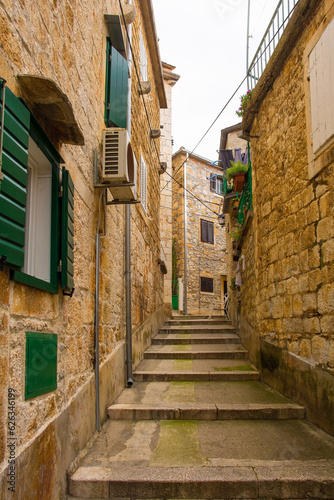 A street of historic stone houses in Milna Village on the west coast of Brac Island in Croatia. Some of the doors are filled in or boarded up © dragoncello