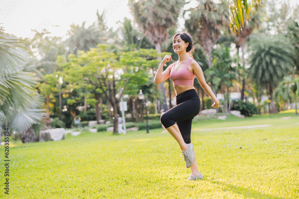 fitness journey of a fit 30s Asian woman wearing pink sportswear as she exercises in a public park at sunset. Explore the concept of wellness and well-being through this inspiring scene