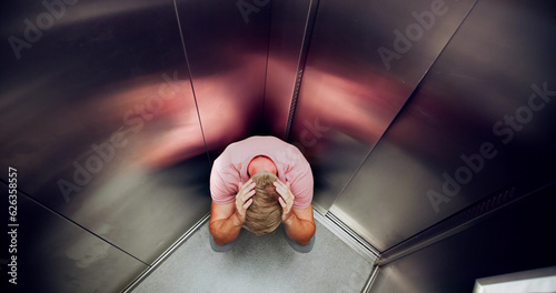 Man Suffering From Claustrophobia Trapped Inside Elevator photo