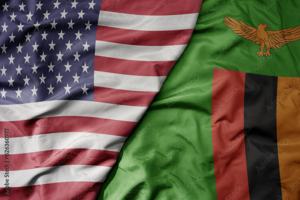 Obraz premium big waving colorful flag of united states of america and national flag of zambia .