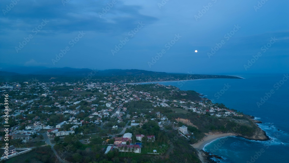 Lunar glow over Bacocho Beach: aerial view of Puerto Escondido, Oaxaca, Mexico
