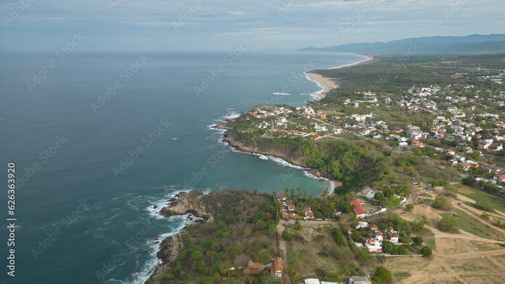 Above Ocean Pacific and houses by the sea near Carrizalillo beach, Puerto Escondido