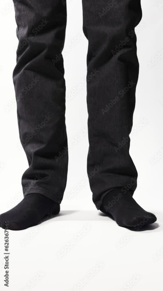 Legs of a man demonstrating black socks on a white background Legs of a man demonstrating black socks on a white background