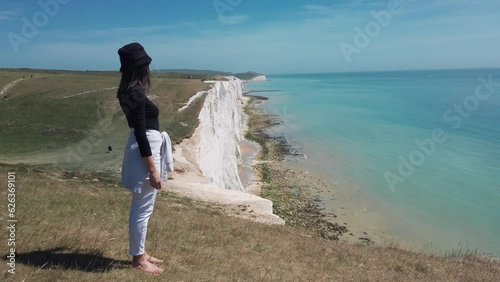 Happy positive barfoot woman enjoy view of Seven sisters clifs at National park, slow motion photo