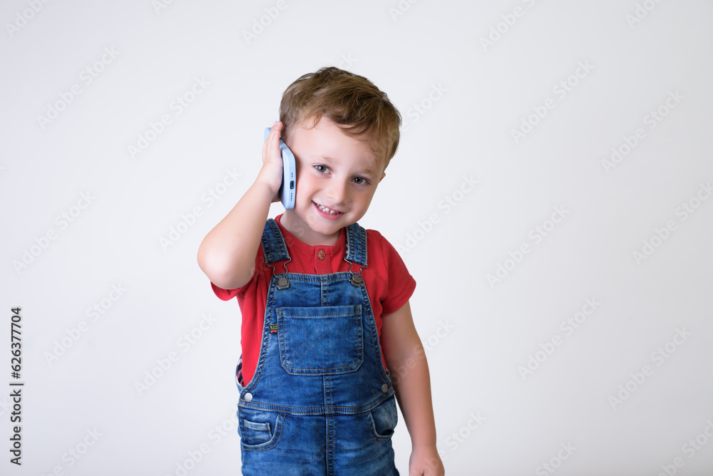 Smiling boy using cell phone isolated in white studio Smiling boy using cell phone isolated in white studio
