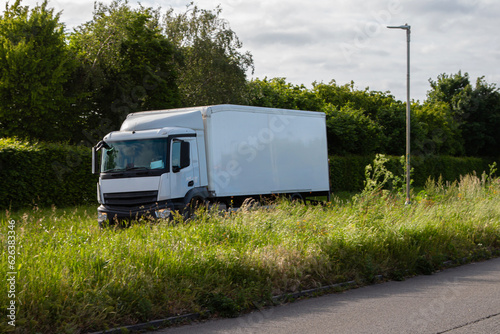 White rigid lorry with white box trailer travelling on the dual carriageway.
