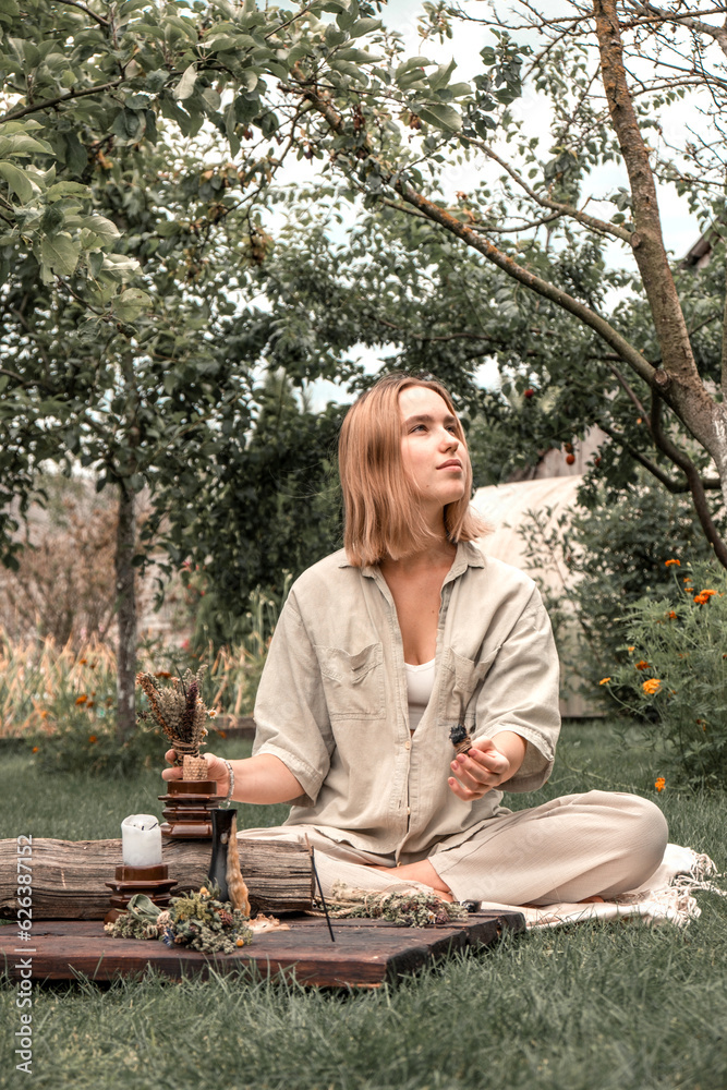 Woman Inhaling Incense Smoke During Meditation.Ground level of relaxed