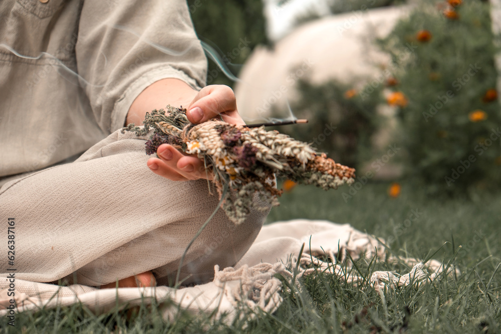 Woman Inhaling Incense Smoke During Meditation.Ground level of relaxed