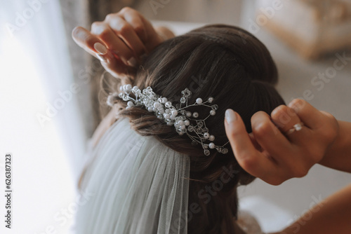 Textured wedding hairstyle with shiny hair accessories. Preparation for the wedding day