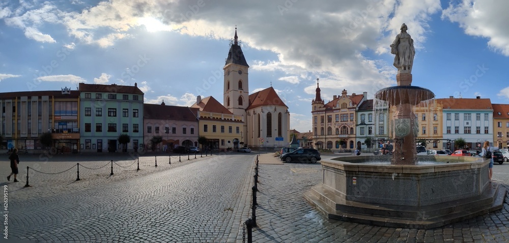 Obraz premium Vodnany historical old town square with fountain,column and his bohemian architecture, surrounding streets and church with tower.Bohemia,Czechia,European union