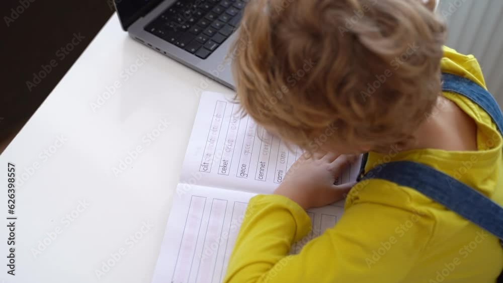 Close up Schoolboy child write exercise alphabet using laptop online educational lesson programming course at home. Distance learning remote video conference. Schoolgirl study does homework. Close up Schoolboy child write exercise alphabet using laptop online educational lesson programming course at home. Distance learning remote video conference. Schoolgirl study does homework.