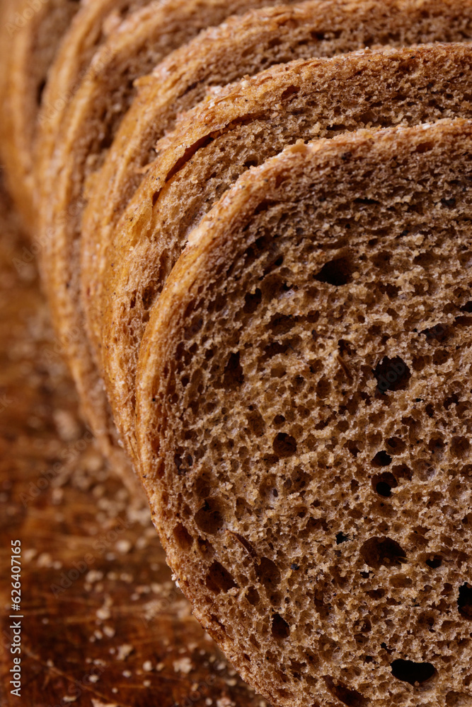 Sliced brown bread covered with bran closeup. Macro shot.
