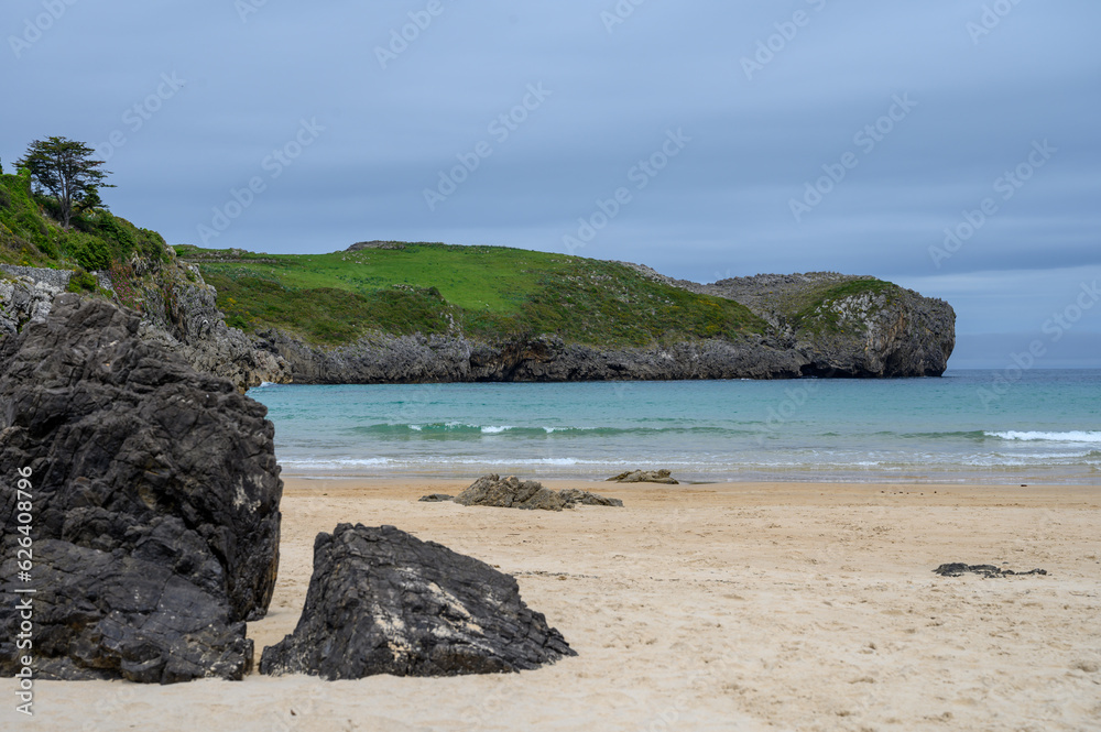 View on Playa de Borizo in Celorio, Green coast of Asturias, North Spain with sandy beaches, cliffs, hidden caves, green fields and mountains. View on Playa de Borizo in Celorio, Green coast of Asturias, North Spain with sandy beaches, cliffs, hidden caves, green fields and mountains.